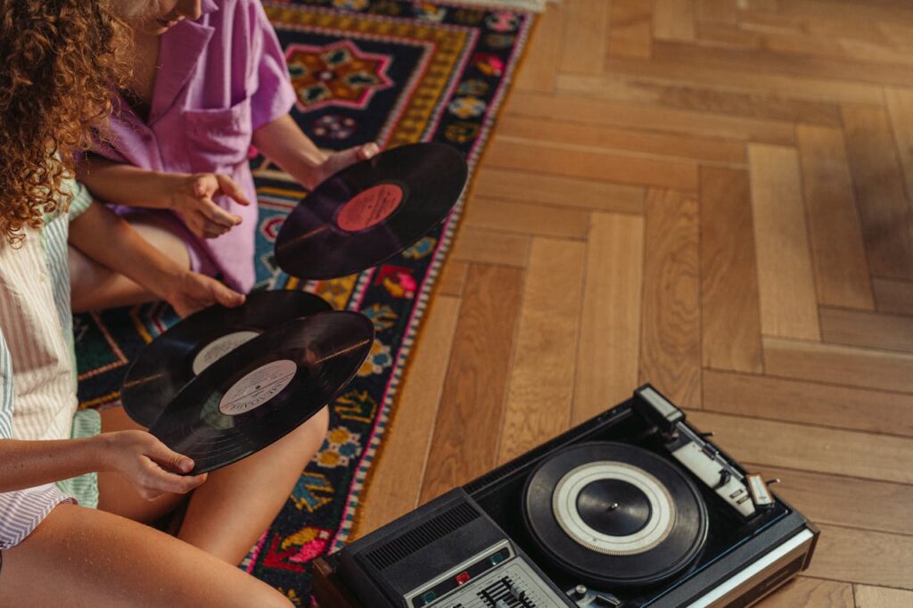 two people sitting together figuring out how to store vinyl records for moving